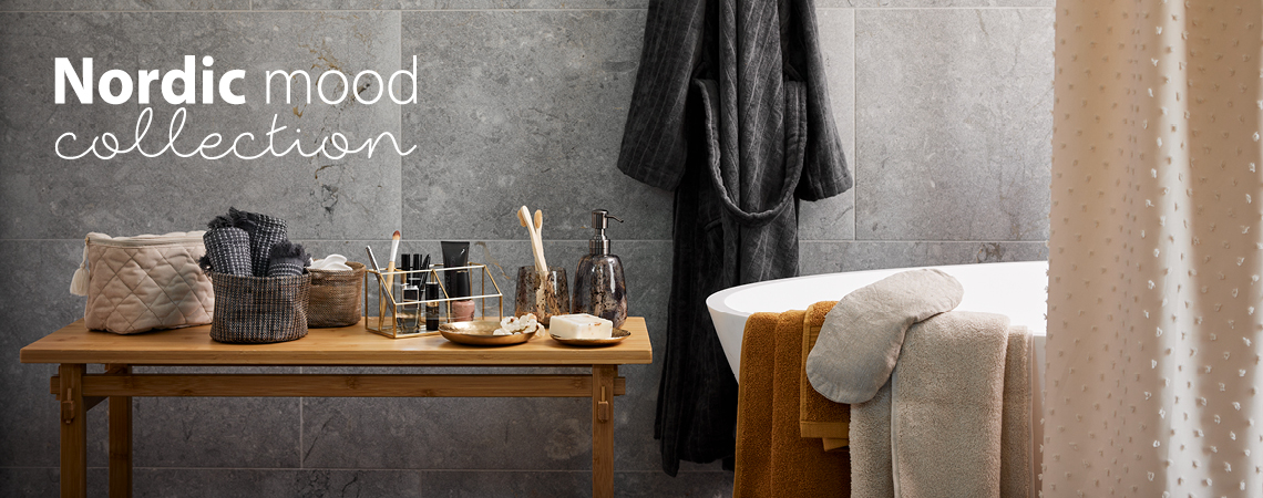 Necessär, smink organisering, tandborsthållare, tvålpump, bomullsbadrock, handdukar och duschdraperi i ett badrum