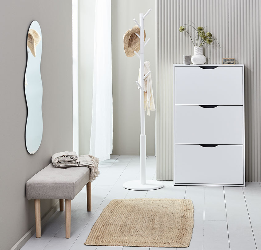 Hall with mirror, bench, shoe cabinet, coat stand and rug with low pile on the floor