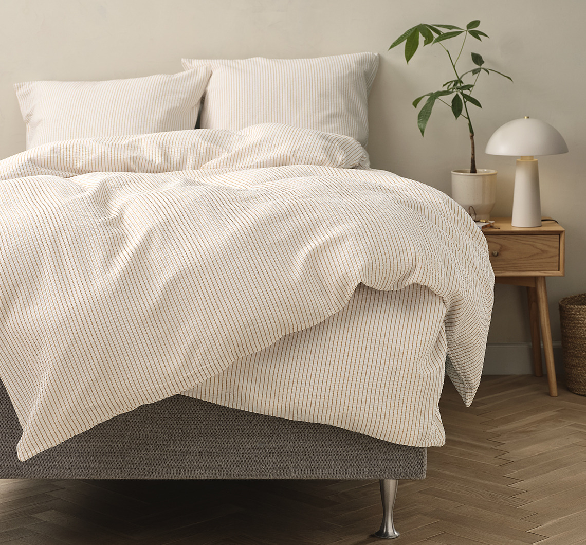 STINNE seersucker bed linen can feel cool on hot summer nights Striped bed linen in a light bedroom