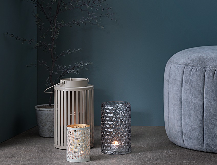 Vase, lantern and tealight holder placed on the floor in a dark corner Vase, lantern and tealight holder placed on the floor in a dark corner