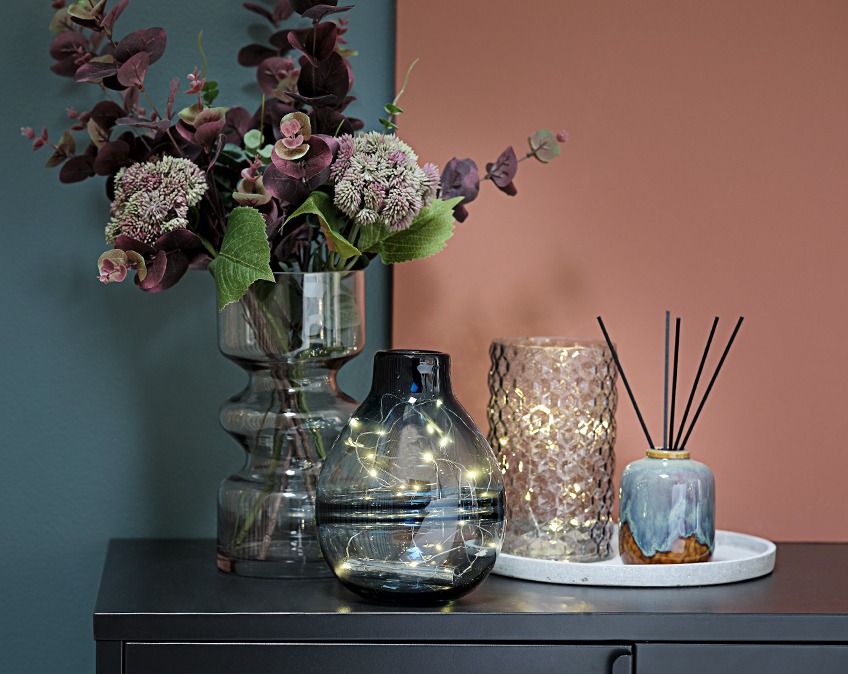 Vases with light strings and flowers on a table Vases with light strings and flowers on a table