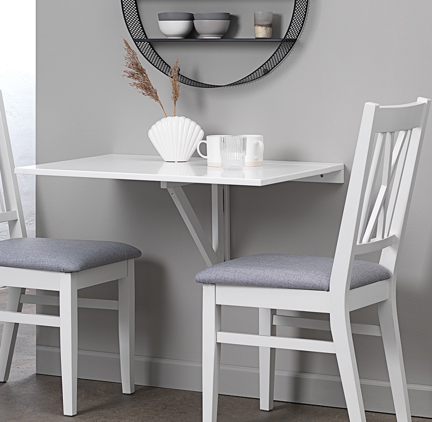 NORDBY wall folding table and NORDBY dining chairs below the round ALLINGE wall shelf White wall mounted folding table and two dining chairs in kitchen nook