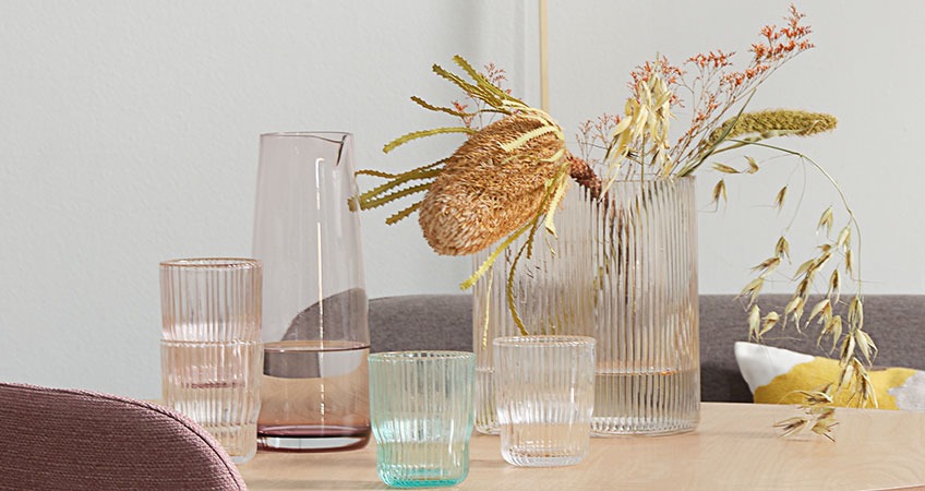Jug, drinking glasses, and vases all in coloured glass