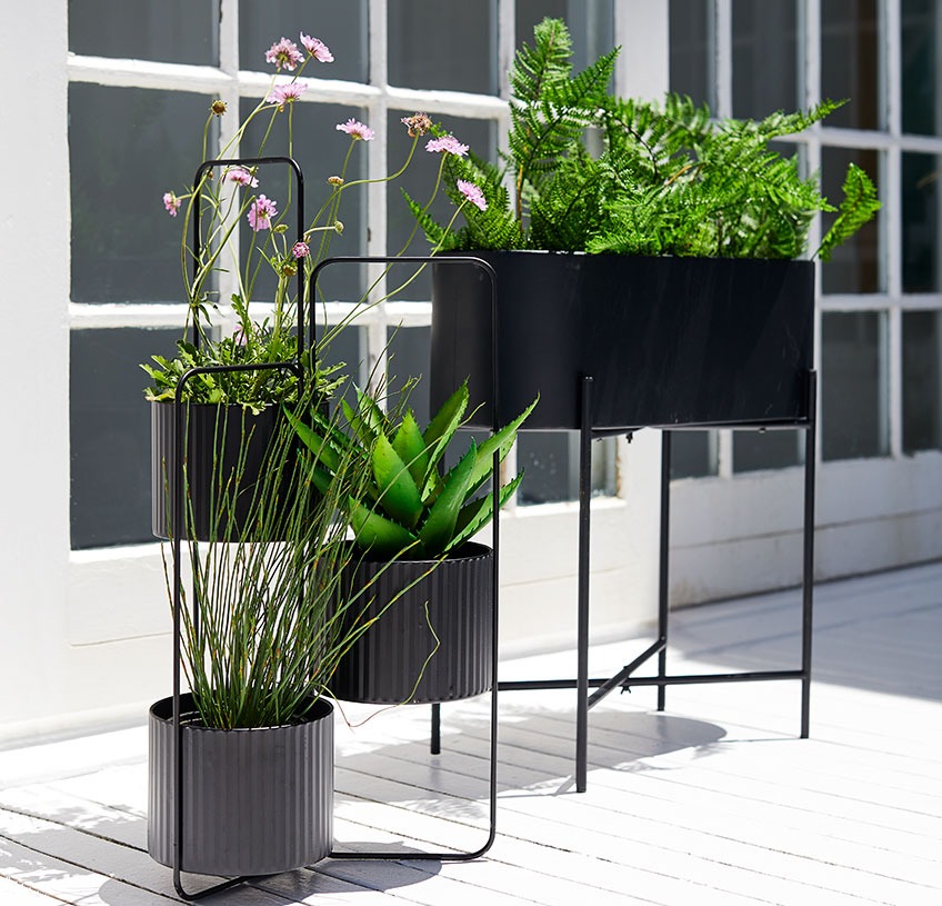 SIMMA planter box and AND plant pot holder Planter box and plant pot holder on a sunny patio