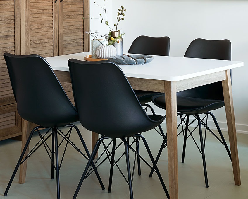 Black dining chairs at a dining table